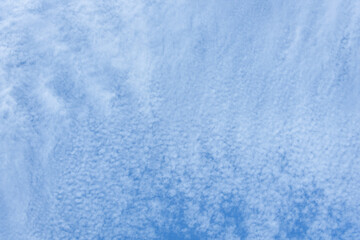 Blue sky and thin white cloud layer as a nature background

