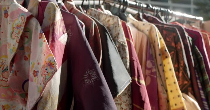 Rows of colorful antique Japanese kimonos hang on the rack at the Oedo Antique Market in Tokyo, Japan.