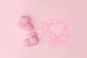 Baby shoes, booties on pink background, first newborn party background, birthday, expectation of newborn, motherhood, maternity, parenthood, minimal monochrome card, banner, copy space