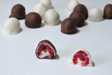 fresh red and shiny fresh raspberries dipped in homemade black and white chocolate