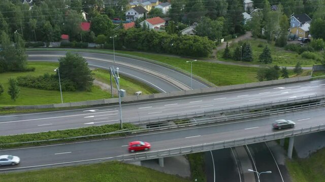 Aerial pan up of a motorway along a suburban area in Finland near Helsinki.