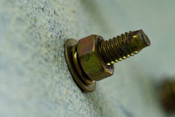 steel hex bolt and nut on the concrete wall