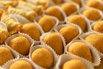 Brazilian gastronomy. Various snacks, such as pastries, chicken drumsticks and risoles.