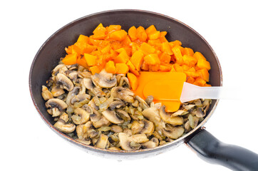 Vegetarian vegetable stew of pumpkin and mushrooms in pan, white background.