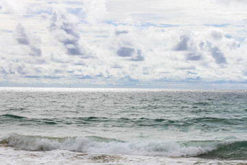 Blue dramatic sky with clouds and stormy sea