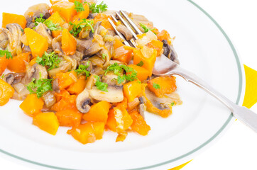 White plate with vegetarian food of vegetables, pumpkin, mushrooms