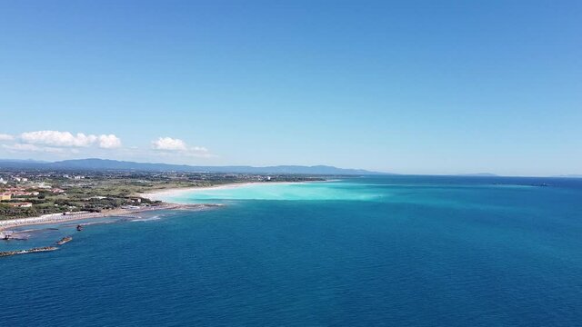 Approaching Spiagge Bianche beaches, Vada from Castiglioncello Cardellino coast. Aerial flying over water. Sunny day, mid July summer. Tuscany Livorno Italy