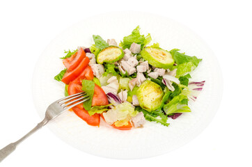 Dietary food, salad leaves with zucchini slices, tomatoes and slices of turkey fillet