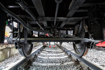View under the old train on wheels.