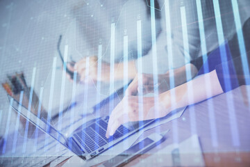 Multi exposure of woman hands typing on computer and financial chart hologram drawing. Stock market analysis concept.