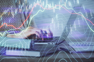 Double exposure of woman hands typing on computer and forex chart hologram drawing. Stock market analysis concept.