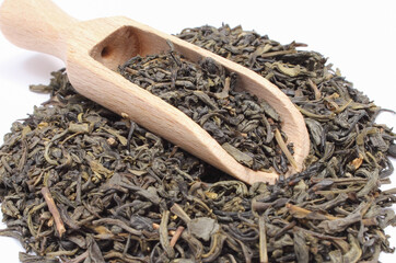 Dried green tea with spoon on white background. Healthy lifestyles