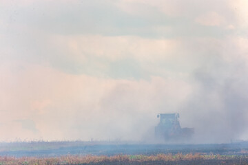 Fototapeta na wymiar truck putting fire down on crop field