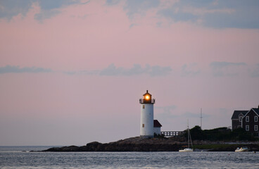 landscape of lighthouse on MA wingaersheek beach seacoast under dusk light