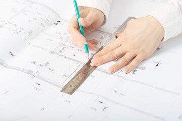 Architecture, design. The architect is working on a drawing in the architectural office