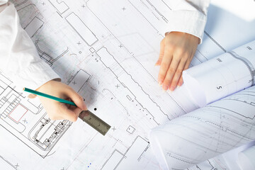 Naklejka na ściany i meble architect designer working on architectural blueprints, building plans in the office, drawing