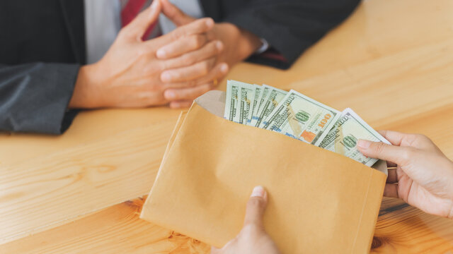 Corruption and venality concept, Businesspeople giving a bribe money.
