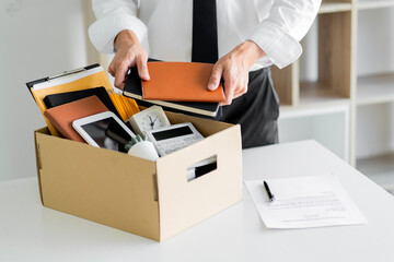 Business person packing a box for resign a job, Unemployment concept.