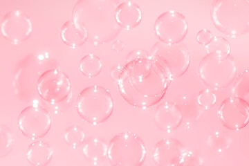 Beautiful blurry clear pink soap bubbles float with reflex background .