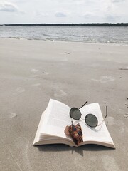 open book on beach, reading, sand