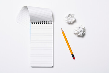 Notebook and pencil on white background
