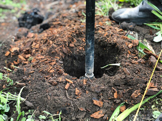 Construction ground drilling with a drill to install a metal profile