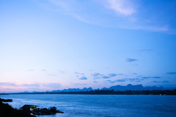 Blue tone sunset sky over Mae Khong river in Nakhon Phanom. Natural border between Thailand and Laos