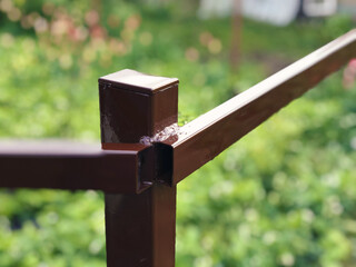 Painted metal structures in brown color close-up in the afternoon