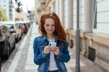 Fototapeta premium Young woman checking a message on her phone