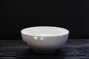 White ceramic bowl empty on wooden table. Asian style of food.