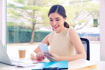 Beautiful young woman working on laptop in office