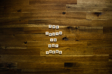 Flat lay photography - Word/s made with lettered tiles on timber background.