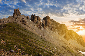 Fototapeta na wymiar rocky mount slope in a light of evening sun, mountain sunset background