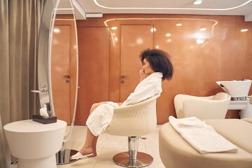 Lovely female resting in modern spa salon