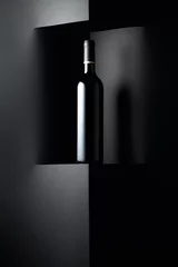 Abwaschbare Fototapete Unopened bottle of red wine on a black background. Copy space. © Igor Normann