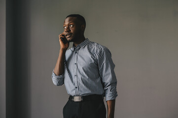 the African-American answered the phone and got some very good news. happy african guy euphoric...