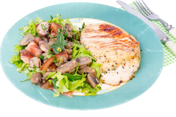Grilled chicken breasts and lettuce green leaves with champignons. Studio Photo