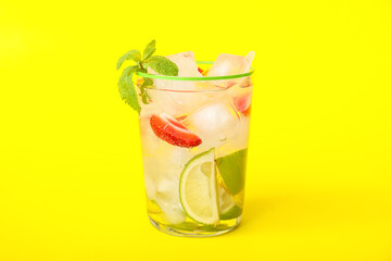 Glass of fresh strawberry lemonade on color background