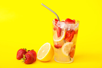 Glass of fresh strawberry lemonade on color background