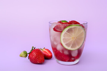 Glass of fresh strawberry lemonade on color background