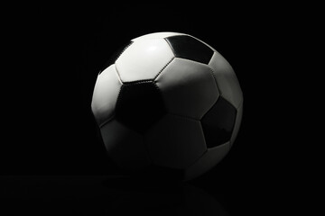 Fototapeta na wymiar Soccer ball on dark background
