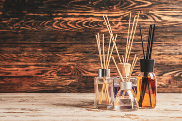 Different reed diffusers on table - obrazy, fototapety, plakaty