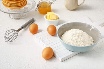Ingredients for pancakes on white background