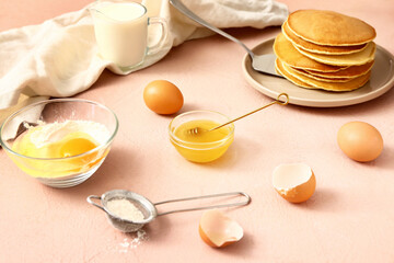 Ingredients for pancakes on color background