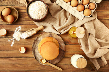Fototapeta na wymiar Tasty pancakes with ingredients on table