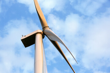 Windmill for electric power on sky background