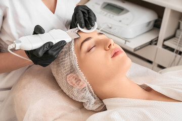 Obraz na płótnie Canvas Woman undergoing procedure of facial peeling in beauty salon