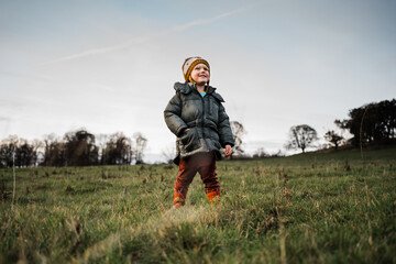 Naklejka na ściany i meble a little boy in a field in winter
