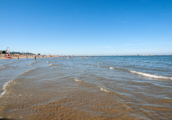 Obraz premium People are resting on a sunny day at the beach in Cesenatico, Italy