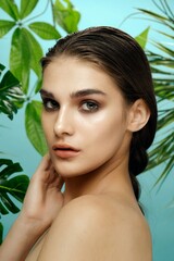 Tropical jungle woman with bare shoulders bright makeup clean skin 
